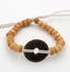 BRACELET BEIGE EN PERLES DE BOIS ET PIÈCE CHINOISE