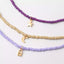 Ensemble de 3 colliers en perles. Violet et or