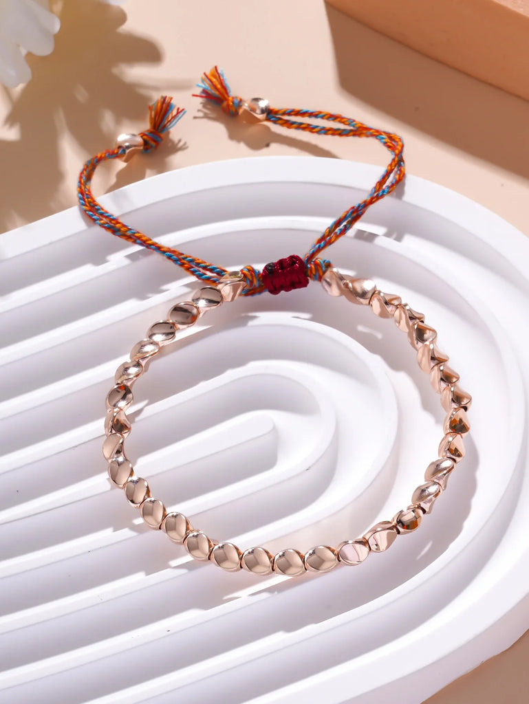 Bracelet de chance en perles de cuivre rose - façon Bouddhisme Tibétain